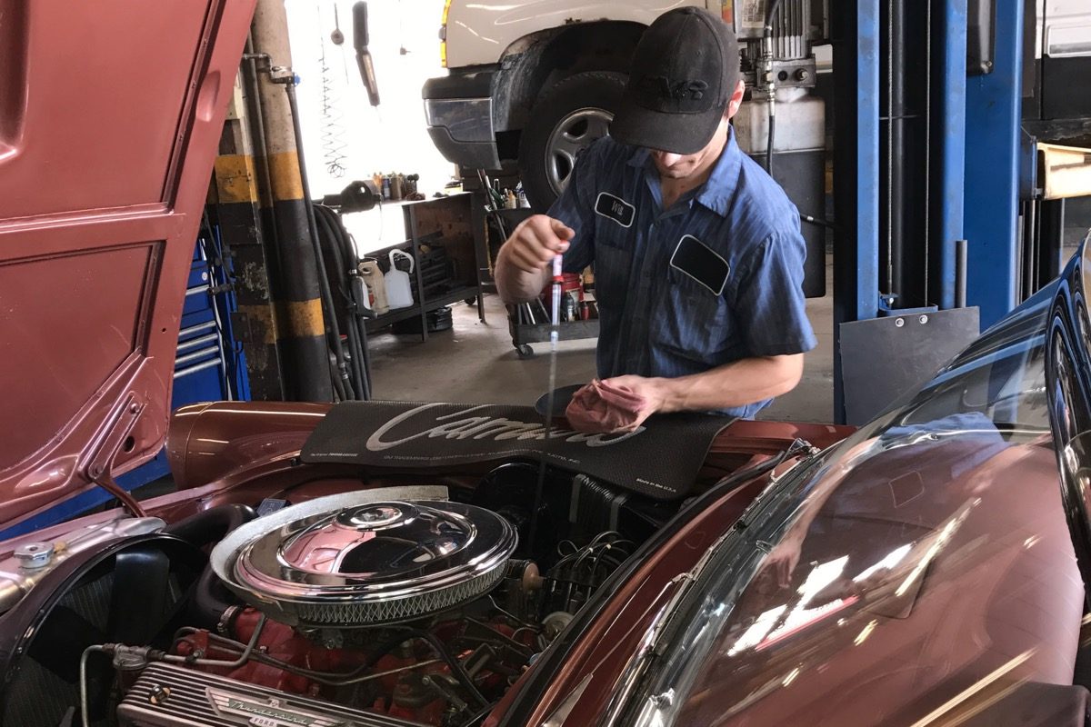 A Franklin mechanic checking the oil